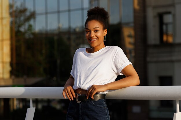 Foto garota africana em t-shirt branca sorri no verão