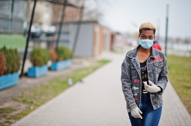 Foto garota africana no parque usando máscaras médicas protege de infecções e doenças quarentena de vírus de coronavírus.