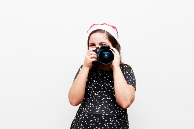 Garota com chapéu de natal fotografada, fundo branco