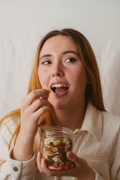 Garota comendo um pedaço saudável de frutas secas