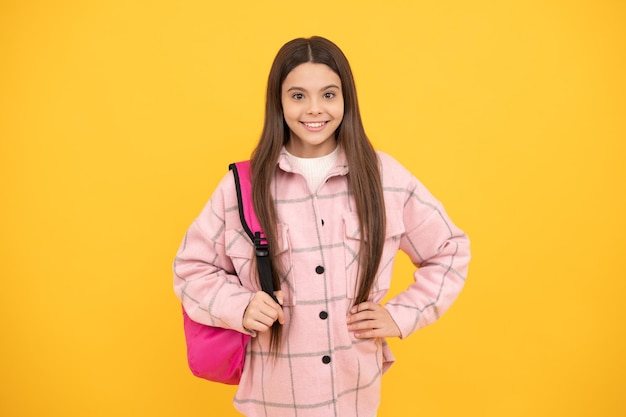 Garota criança feliz usa camisa xadrez rosa carrega mochila escolar infância