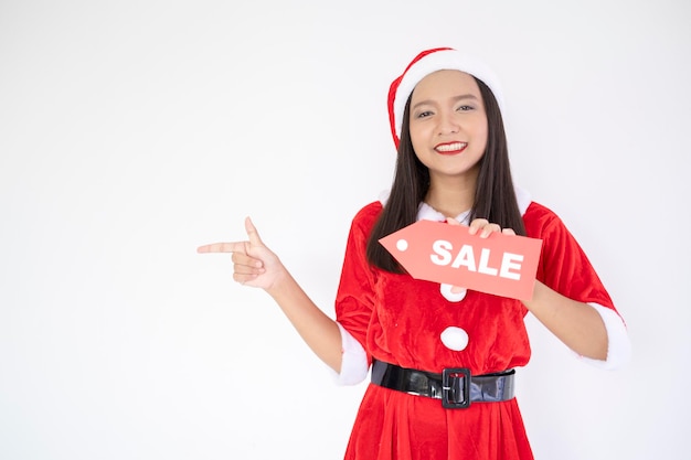 Garota de Papai Noel segurando um cartaz à venda, garota feliz de Papai Noel.