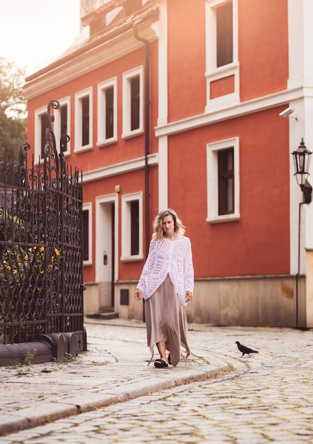 Garota romântica positiva no centro da cidade, foto de uma incrível loira com maquiagem natural, parece feliz andando ao ar livre