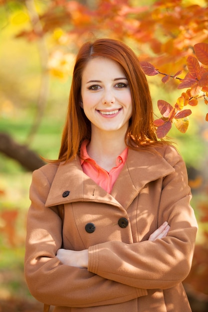 Garota ruiva no parque outono