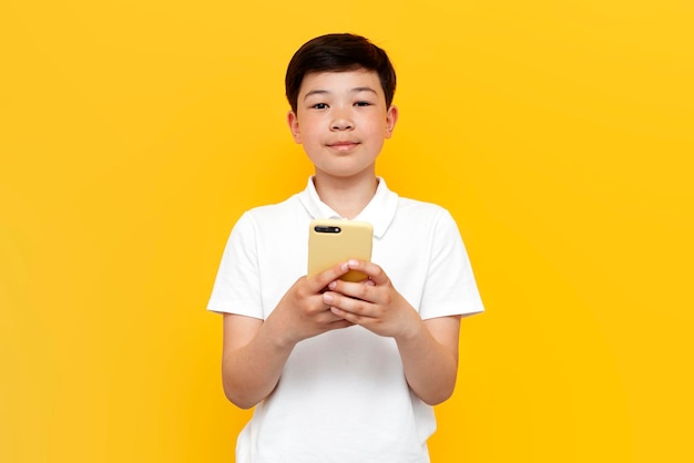 Menino Tailandês Asiático Do Preteen Que Usa Um Smartphone Para