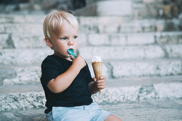 Garotinho comendo sorvete ao ar livre Kid com gelato na antiga rua da Itália