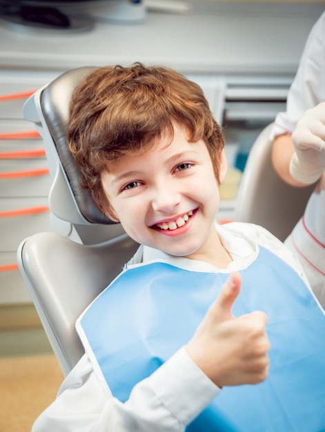 Garotinho sorrindo no consultório odontológico