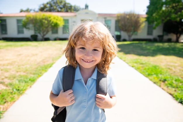 Garoto da escola feliz e engraçado enfrenta garoto da escola primária correndo na escola