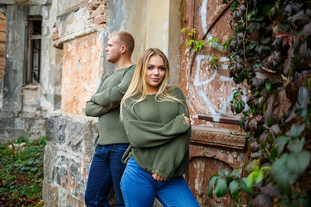 Garoto e garota em jeans e suéteres verdes