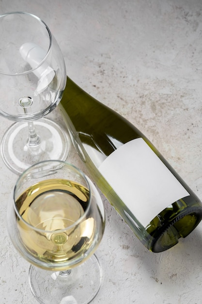 Garrafa de vinho branca com rótulo vazio e copos, logotipo da maquete em fundo branco
