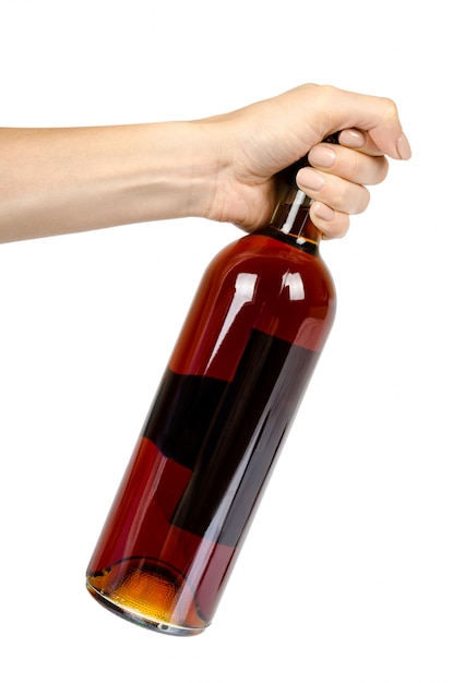 Garrafa fechada de vinho com a mão, álcool e conceito de dependência