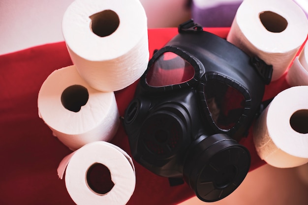 Gasmaske und viel Toilettenpapier in Ihrem Haus. Covid-19-Konzept Übertreibung