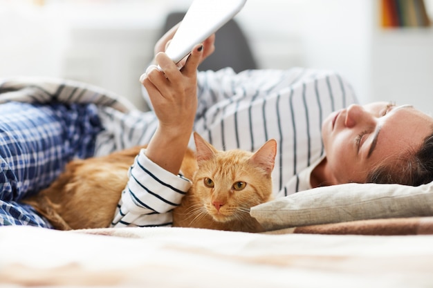 Gato deitado na cama com o proprietário