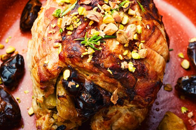 Gebackenes Schweinefleisch mit Datteln, Äpfeln und Pistazien. Gebratenes mageres Schweinefleisch.