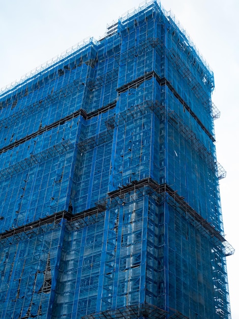 Gebäude im Bau eingewickeltes blaues Schutzsicherheitsnetz