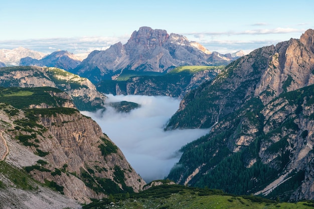 Gebirgsschlucht gefüllt mit Wolken bei Sonnenaufgang in den italienischen Alpen der Dolomiten, italienische Berglandschaft