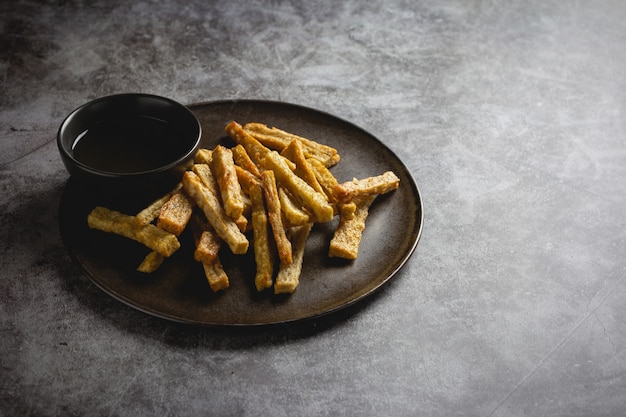 Gebratene Fischsnacks namens Keropok Lekor auf Beton.