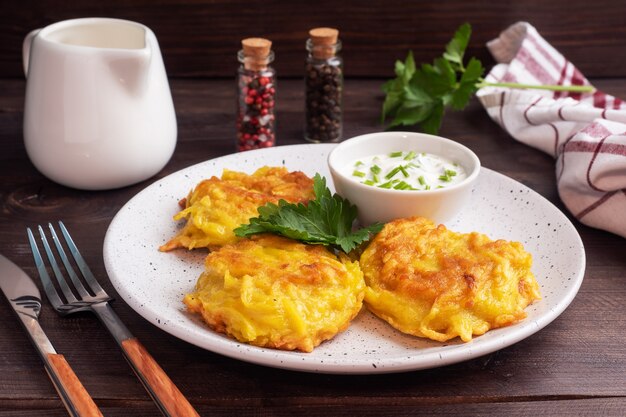 Gebratene Kuchen von geriebenen Kartoffeln mit Sauce.