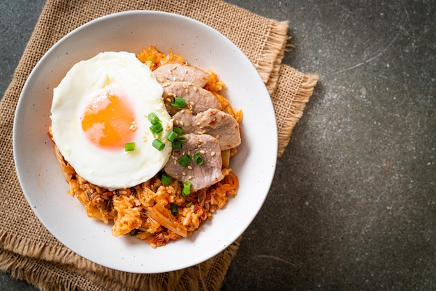 Gebratener Kimchi-Reis mit Spiegelei und Schweinefleisch - koreanische Lebensmittelart