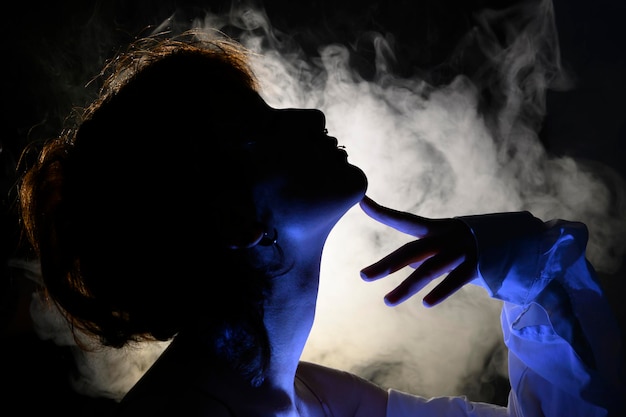 Foto gebrauchte rauchsilhouette eines mädchens im dunkeln