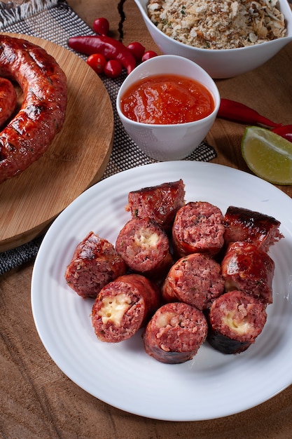 Gegrillte brasilianische Wurst gefüllt mit Käse auf einem Holzbrett. Brasilianischer Grill.