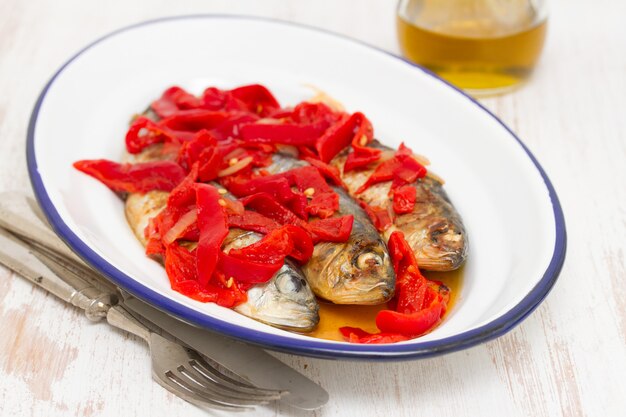 Gegrillte Sardinen mit rotem Pfeffer auf weißer Schale