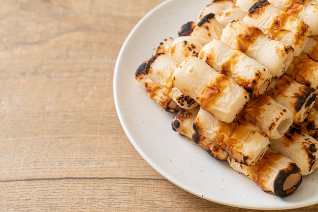 gegrillter röhrenförmiger Fischpastetenkuchen oder Röhrentintenfischspieß auf Teller