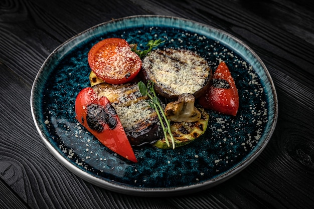 Gegrilltes Gemüse auf einem dunklen Holztisch