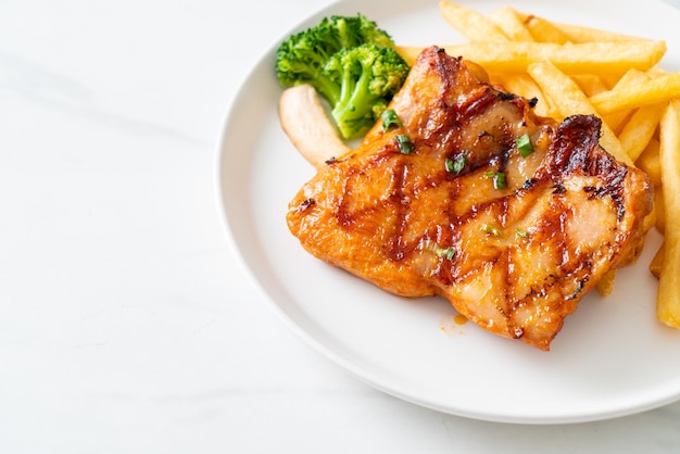 Gegrilltes Hühnersteak mit Kartoffelchips oder Pommes Frites