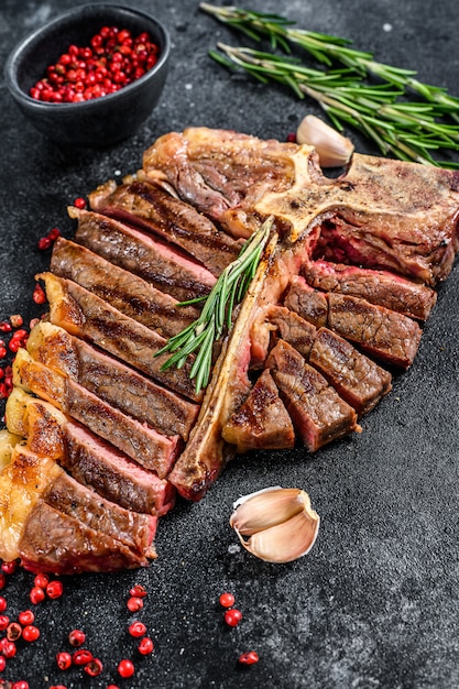 Gegrilltes T-Bone-Steak. Gekochtes Rindfleisch mit Knochen. Schwarzer Raum. Draufsicht