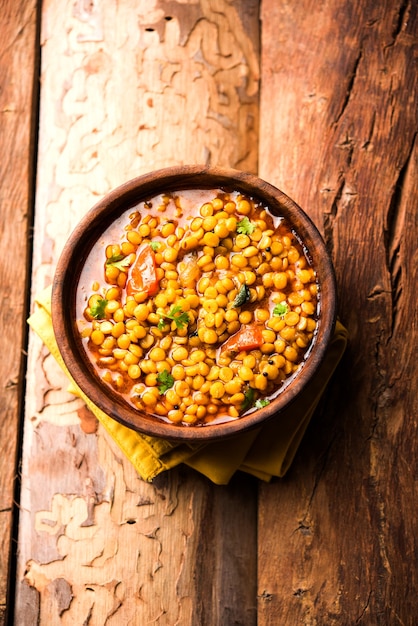 Gekochte Chana Dal Fry oder Split Bengal Gram Tadka serviert in einer Schüssel oder Pfanne, selektiver Fokus