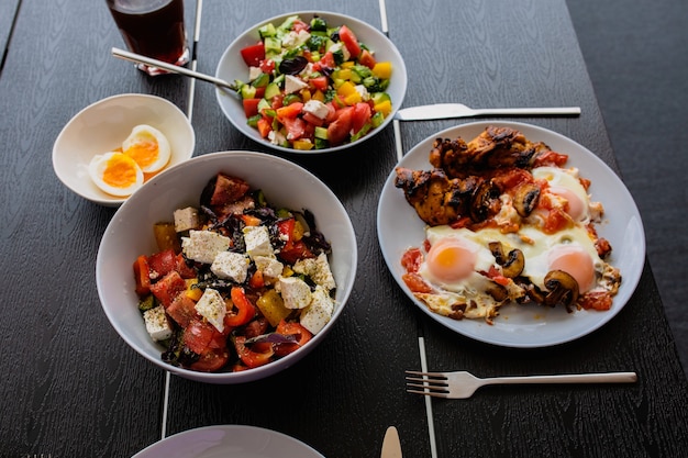 Gekochtes Rührei mit Salat Shakshuka serviert auf der Sommerterrasse Frühstück im Freien Fried