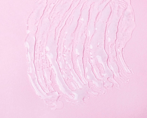 Gel líquido cosmético em um fundo rosa Manchando o fundo abstrato texturizado perfeito