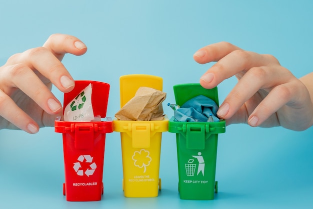 Gelbe, grüne und rote papierkörbe mit recycling-symbol