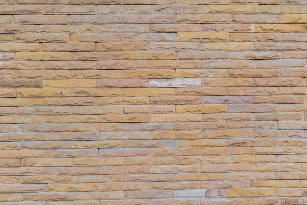 gelbe Steinmauer mit Steinblöcken für den Hintergrund verwendet