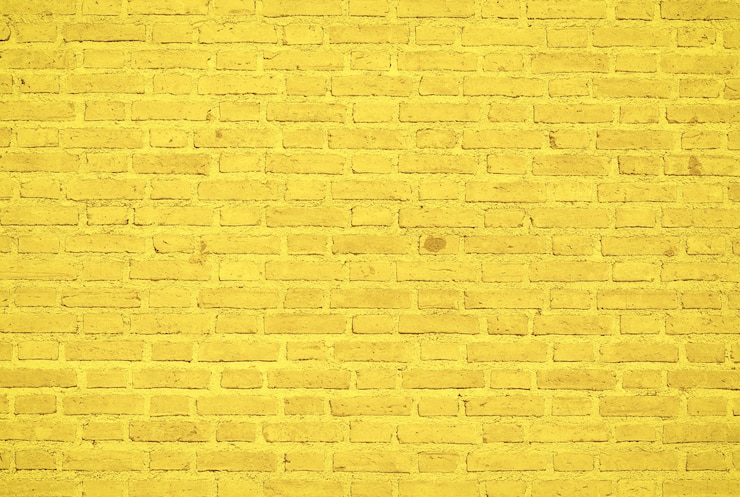 Foto gelber backsteinmauerbeschaffenheitshintergrund