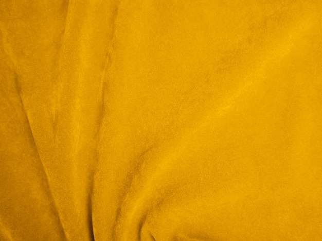 Gelber Samtstoff als Hintergrund verwendet Leerer gelber Stoffhintergrund aus weichem und glattem Textilmaterial Es gibt Platz für Text