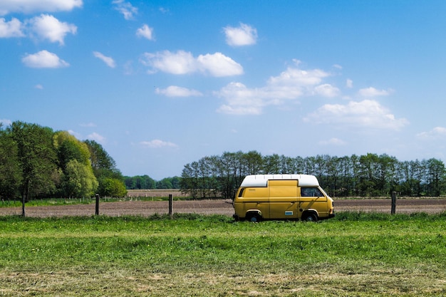Gelbes Auto auf dem Feld gegen den Himmel