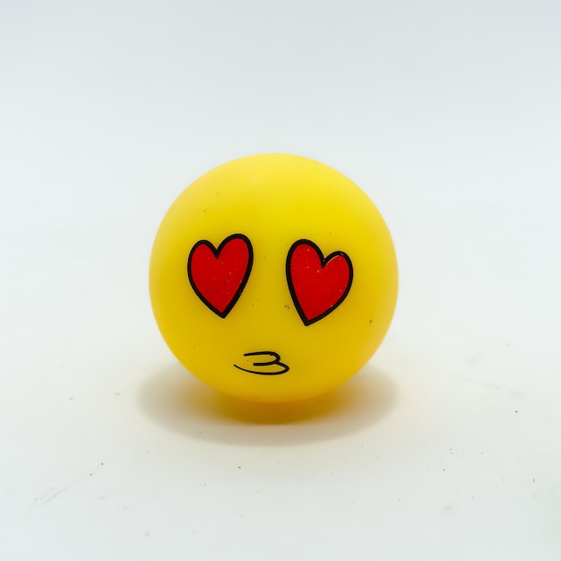 Foto gelbes gummispielzeug mit gesichtsausdruck, gelbes emoticon isoliert auf weißem hintergrund