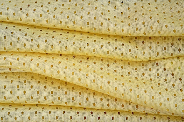 Gelbes Maschensportabnutzungsgewebe-Textilhintergrundmuster