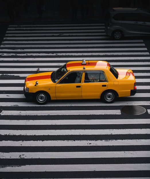 Gelbes Taxi auf einem Zebrastreifen in Japan