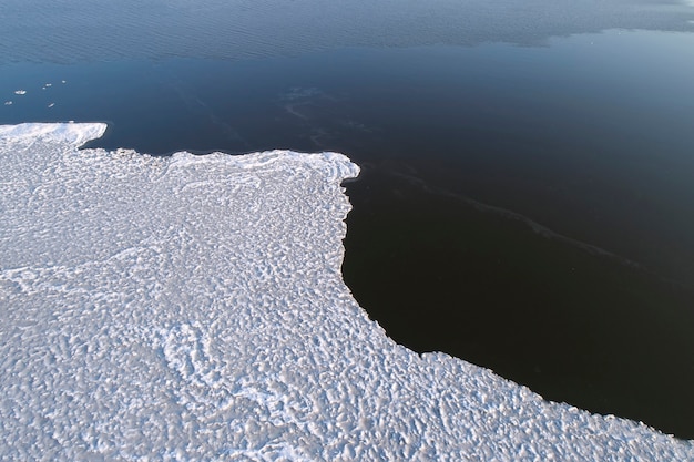 Gelo congelado na margem do reservatório como pano de fundo, uma visão panorâmica. Início do inverno