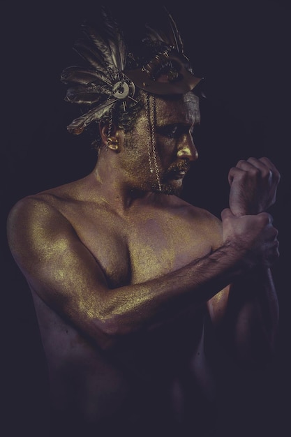 gemalte goldene Körperfarbe, Mann mit goldenem Helm, alte Kriegergottheit