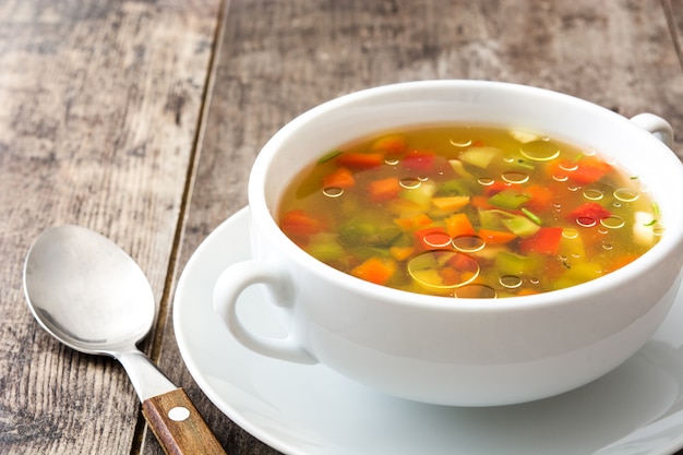 Foto gemüsesuppe in der schüssel auf holztisch