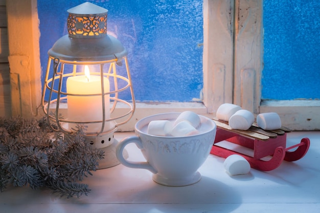 Genießen Sie Ihre leckere Weihnachtsschokolade mit Marshmallows und Kerze
