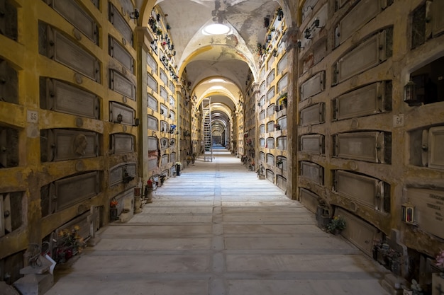 Foto genoa, itália - junho de 2020: corredor com estátuas - início de 1800 - em um cemitério católico cristão - itália