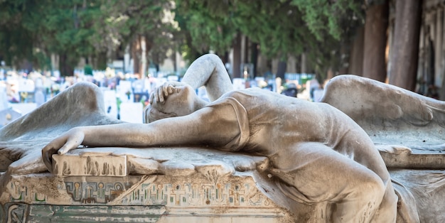 Génova, Italia - junio de 2020: estatua antigua de ángel (1910, mármol) en un cementerio católico cristiano - Italia