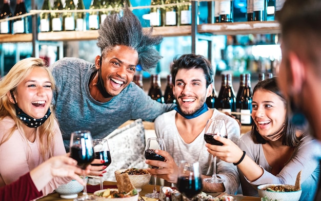 Gente bebiendo vino tinto en el restaurante bar fusión