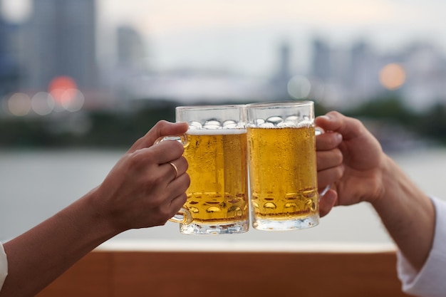 Gente brindando con pesadas jarras de cerveza