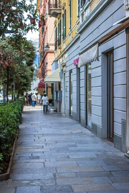 Gente caminando por la acera junto a un edificio en la ciudad